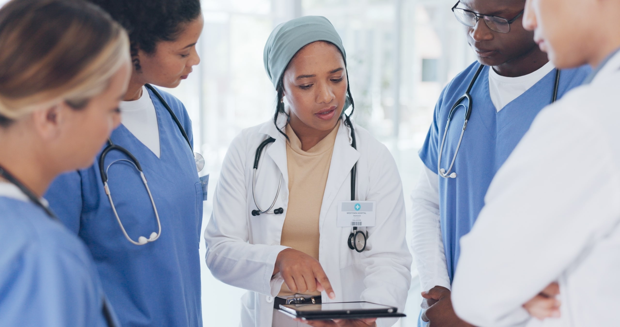 Medical professional mentoring diverse group of people