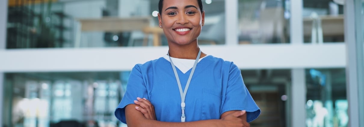 Smiling nurse with her arms crossed in a hospital
