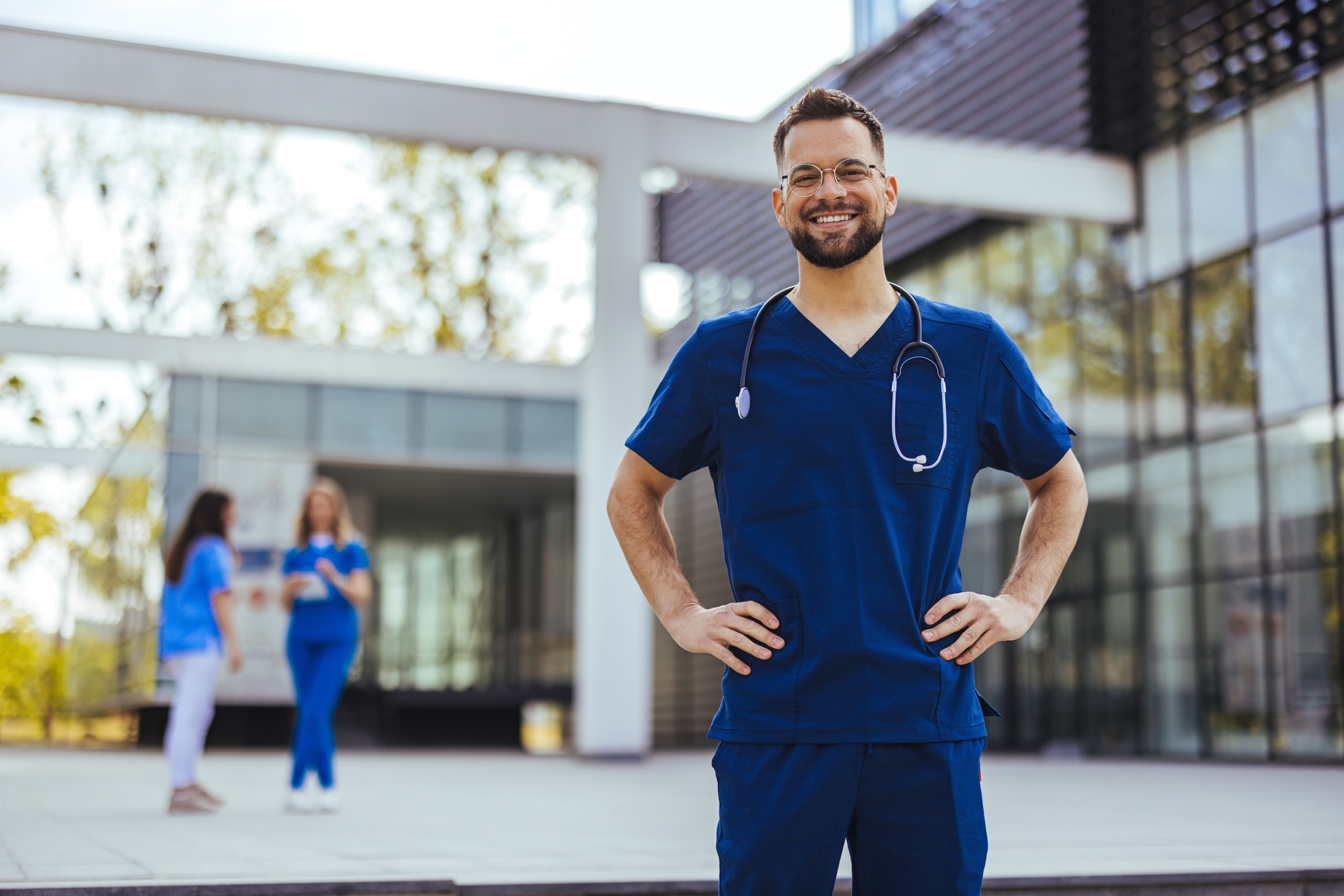 Smiling medical professional with their hands on their hips