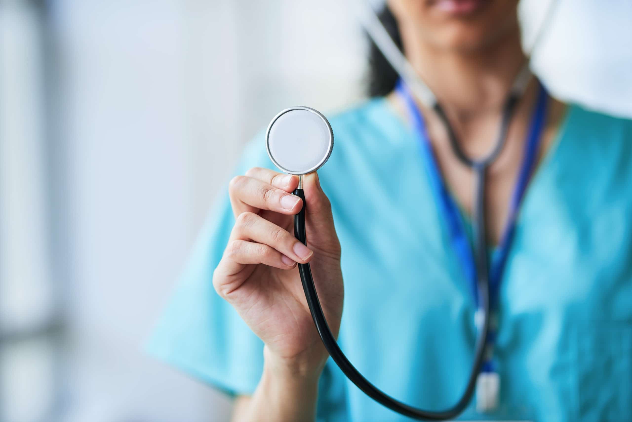 Close up of a medical professional holding a stethoscope