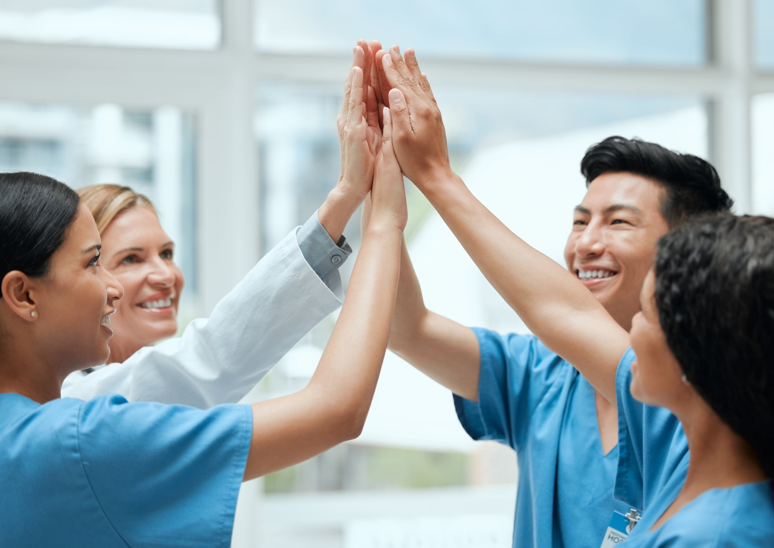 Team of medical professionals touching hands as a sign of teamwork