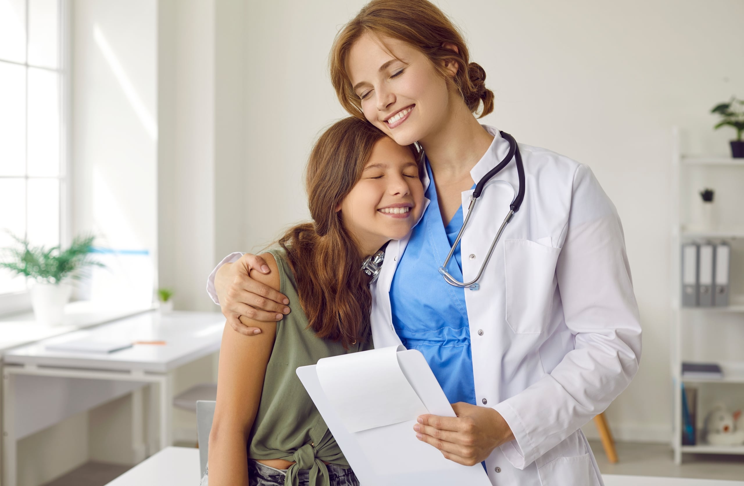 Happy medical professional hugging their patient