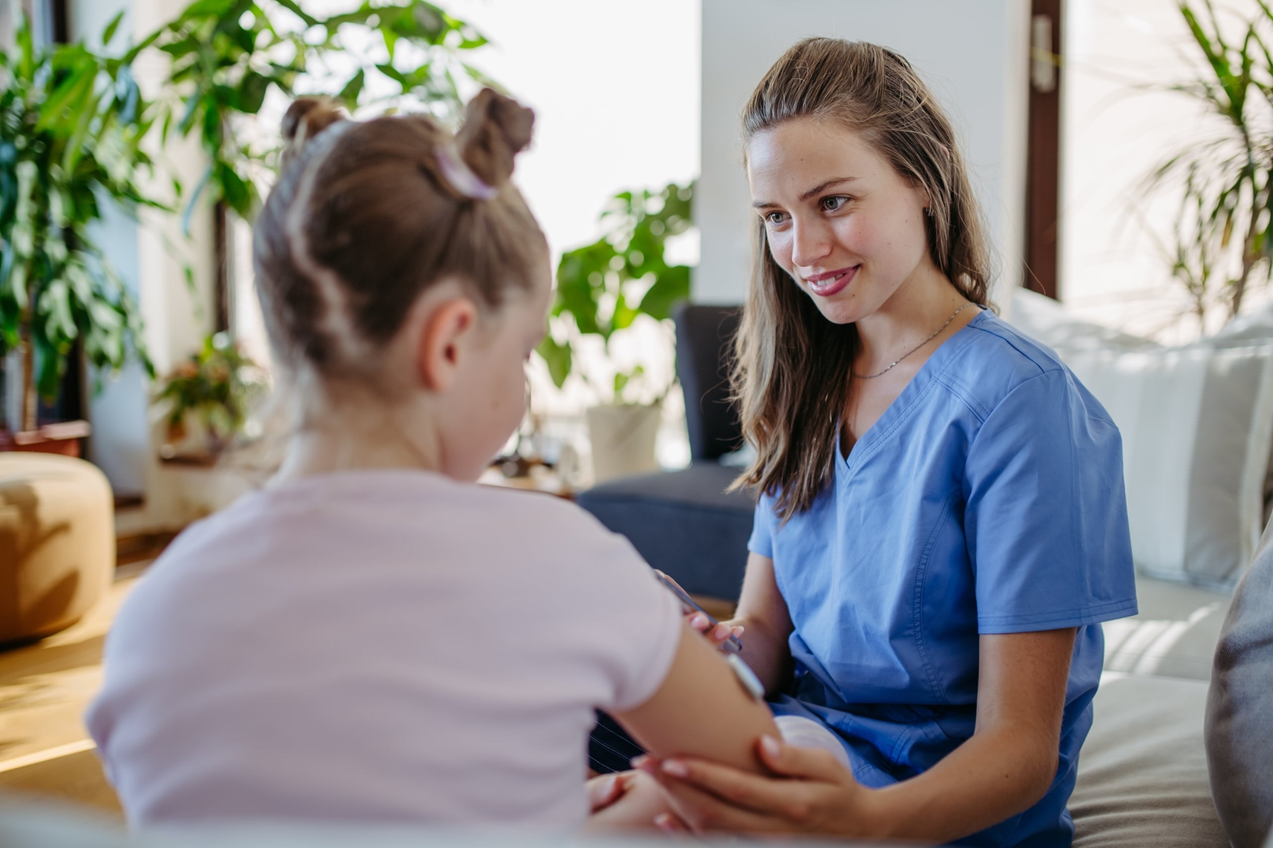 Young nurse treating a child at a clinic
