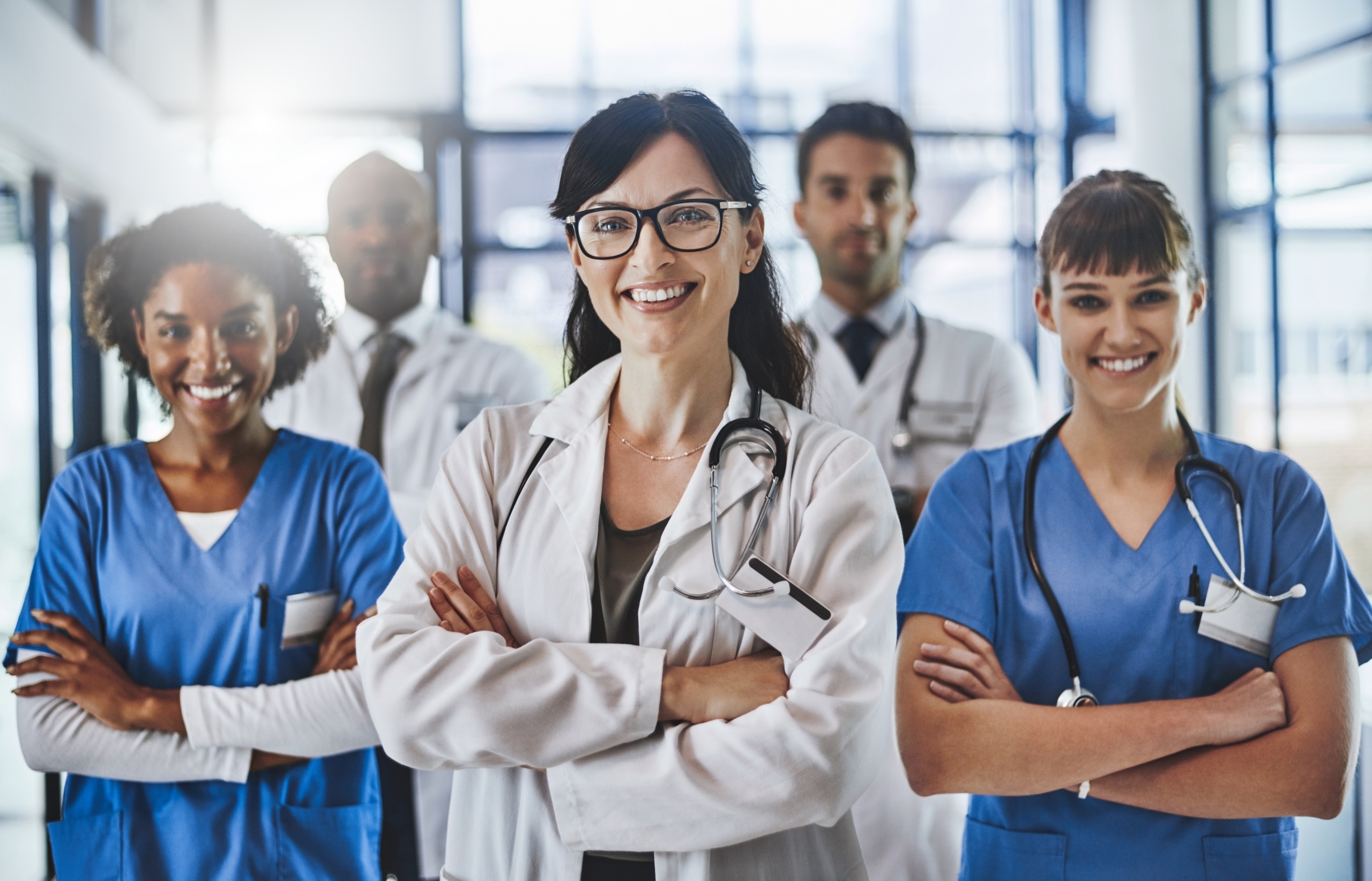 Group of medical professionals standing together with their arms crossed
