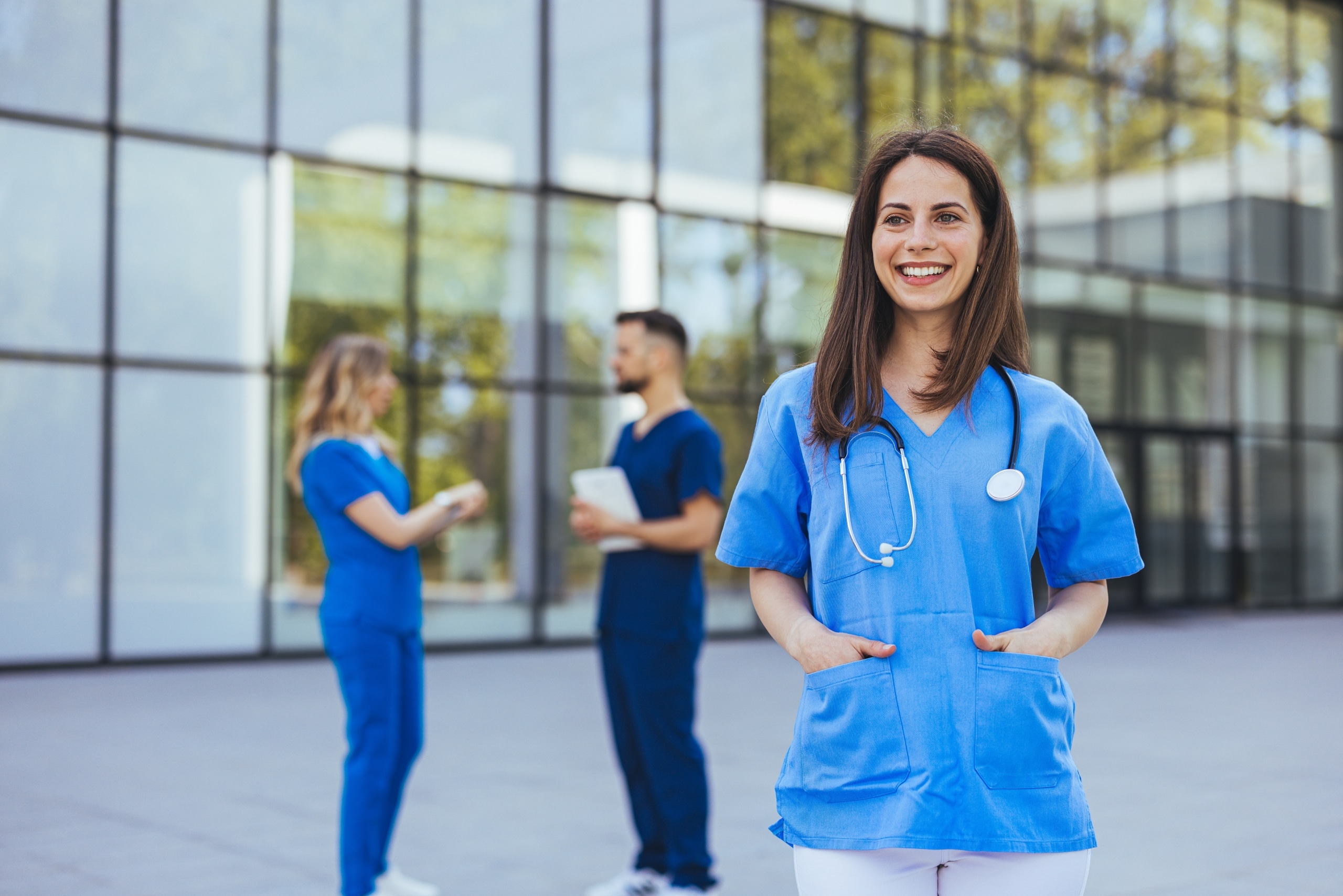 Smiling medical professional standing outside
