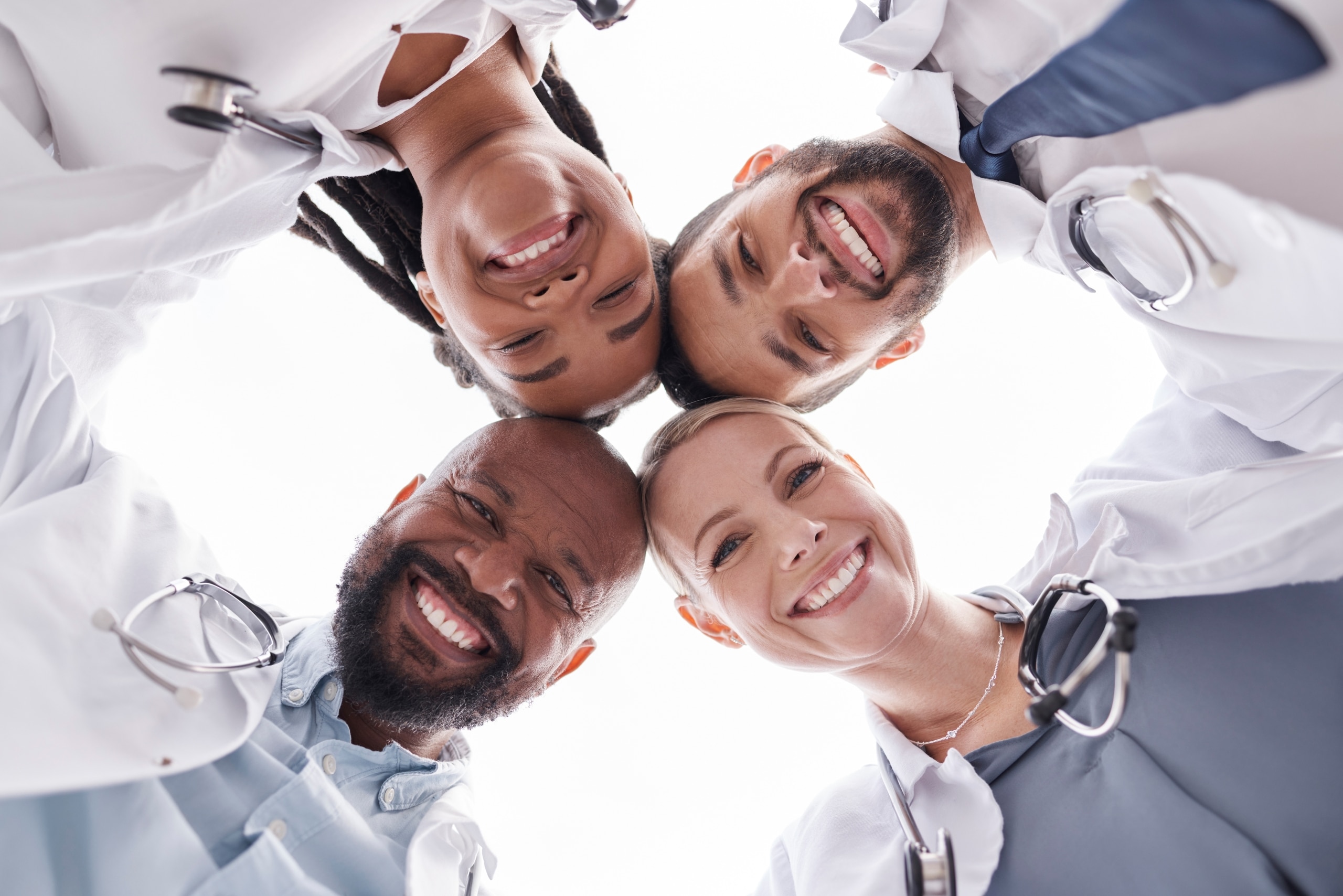 Group of medical professionals in a teamwork circle