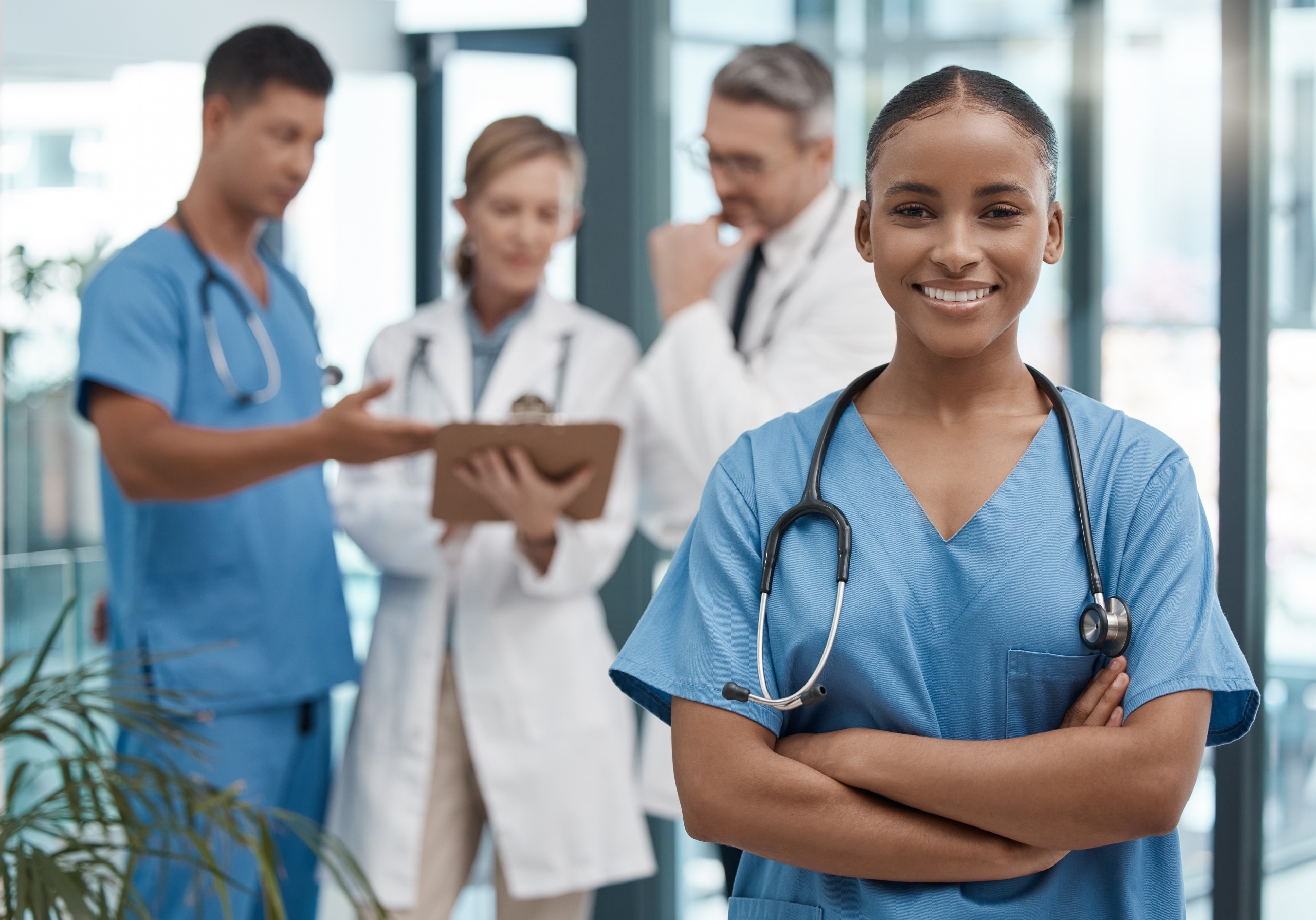 Group of medical professionals consulting each other in a hallway