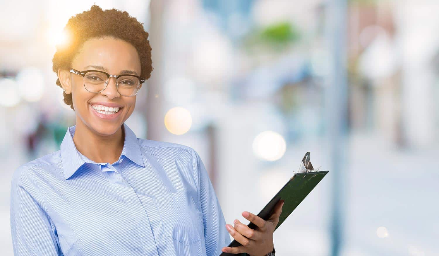 Smiling African-American professional with a clipboard