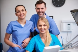 Group of smiling medical professionals in scrubs